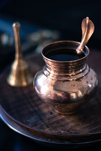 selective focus photography of small jar on brown table beside hand bell thumbnail