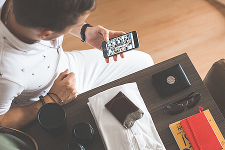 Man Browsing on His Phone While Packing thumbnail