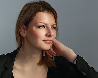 woman wearing black coat smilling thumbnail