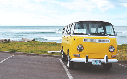 yellow Volkswagen van near body of water thumbnail