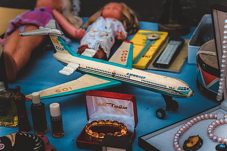 white and blue airliner scale-model near assorted boxes thumbnail