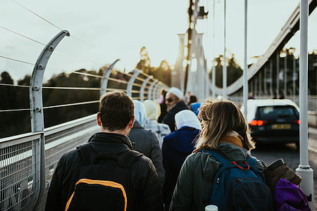 photography of couple walking in line near road at daytime thumbnail