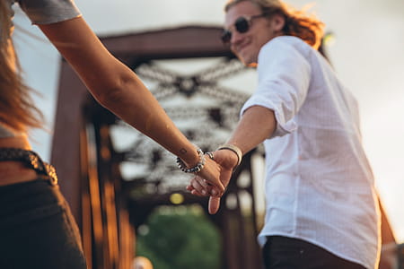 A caucasian couple holding each other s hand at sunset thumbnail