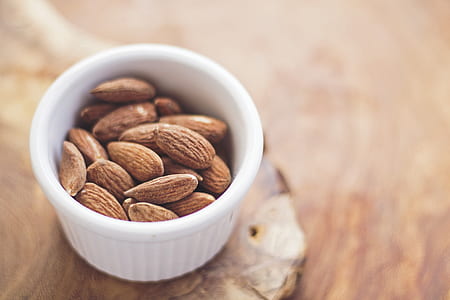 brown almond nuts in round white ramekin thumbnail