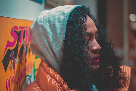 woman wearing gray hoodie leaning on wall thumbnail