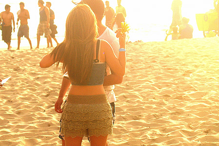 people standing on the beach during sunset thumbnail