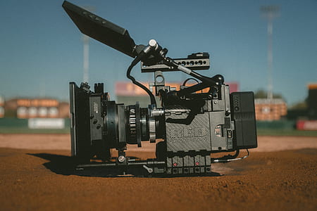 selective focus photography of black professional camera on ground thumbnail