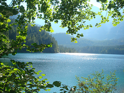 blue body of water near mountain thumbnail