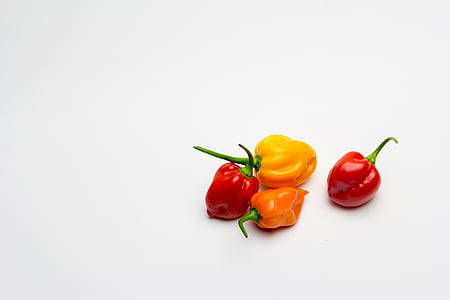 four yellow, red, and orange peppers thumbnail