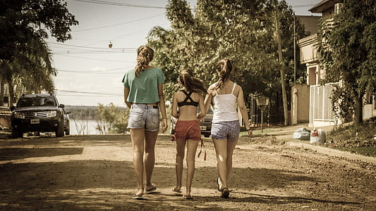 three girls walking on street during daytime thumbnail
