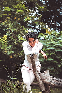 woman leaning on brown wooden branch thumbnail