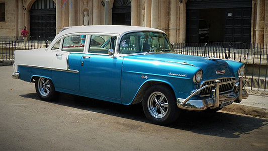 classic blue and white Cadillac sedan parked on roadside during daytime thumbnail