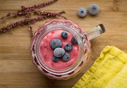 fruit shake on glass mason mug beside yellow towel thumbnail