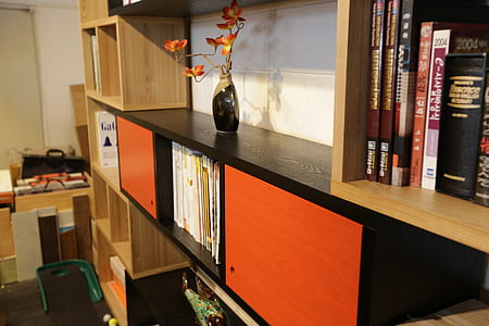 black vase on top of the wooden cabinet thumbnail
