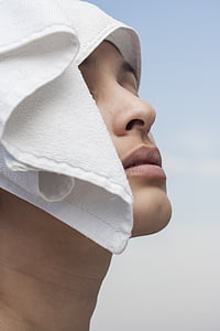 person face covered with white fleece towel thumbnail