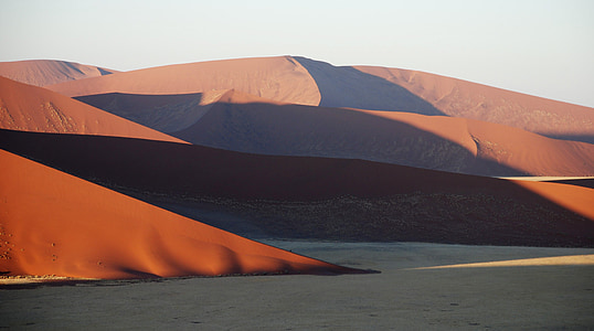 sand dunes under white sky at daytime thumbnail