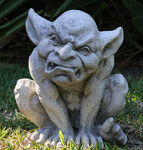 white concrete demon sculpture illustration in green grass thumbnail