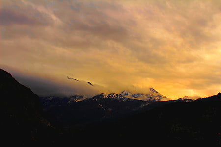 snow covered mountain under cloudy sky thumbnail