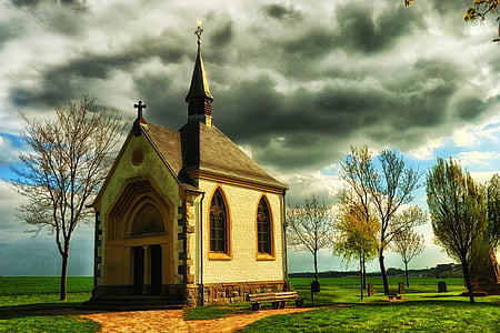 brown cathedral under white clouds thumbnail