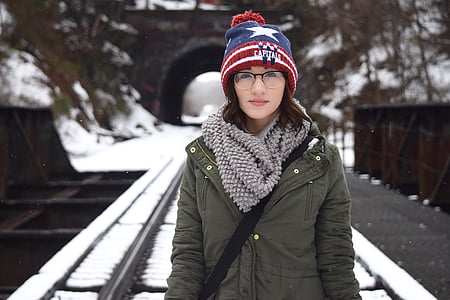 shallow focus photography of smiling woman in gray winter jacket thumbnail