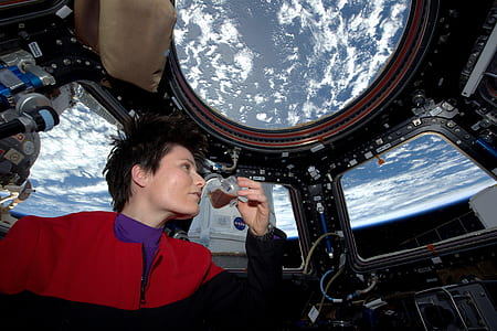 person in red and black zip-up jacket sipping drink thumbnail