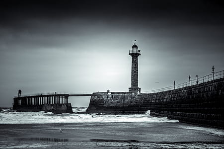 lighthouse beside body of water thumbnail