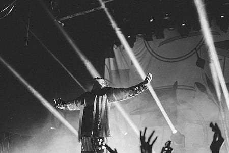 man lifting his arms on the stage thumbnail