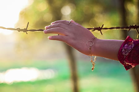 person in gold-colored bracelet thumbnail