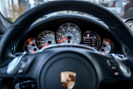 black Porsche steering wheel and instrument cluster panel thumbnail
