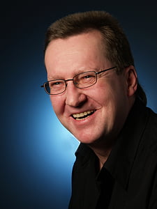 man wearing black framed eyeglasses while smiling thumbnail