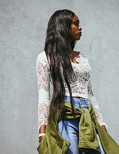 women standing near gray wall thumbnail