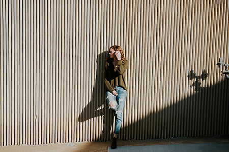 woman leaning on gray wall thumbnail