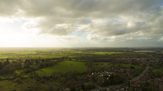 aerial view of city under cloudy sky thumbnail