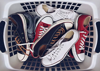 assorted-color footwear lot in rectangular white plastic basket thumbnail