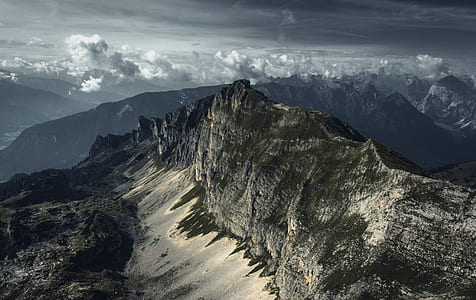 snowy mountain under cloudy sky during daytime thumbnail