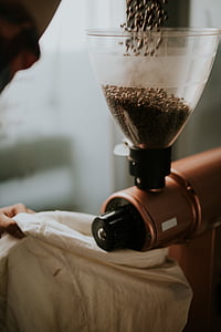 person pour coffee bean to coffee grinder thumbnail