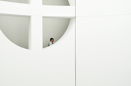 man standing near window during daytime thumbnail