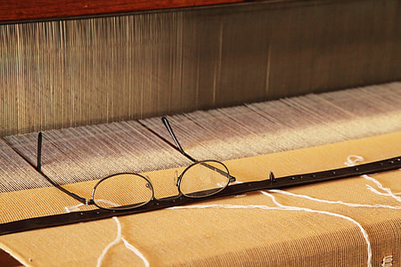 black framed eyeglasses on manual weaving machine thumbnail