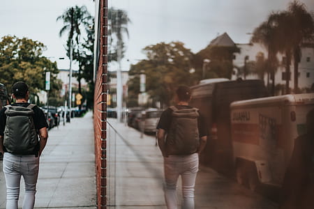 person walking beside wall thumbnail
