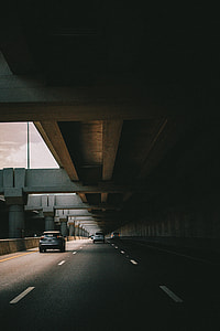 road with cars with concrete structure above thumbnail