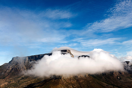 white cloud covering brown rocky mountain during day time thumbnail