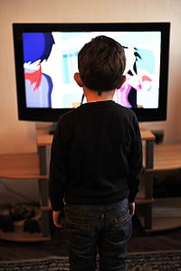 kid in black crew-neck sweater standing in front of black flat screen television thumbnail