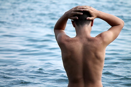 topless man on body of water thumbnail