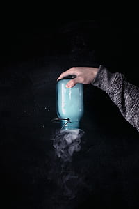 time lapse photography of person holding Mason jar with smoke thumbnail