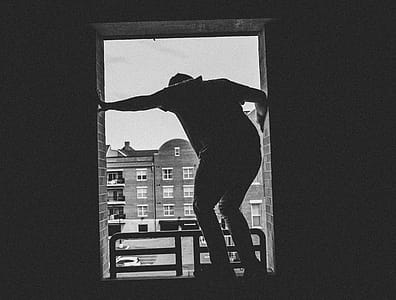 Grayscale Photo of Person Near Building thumbnail