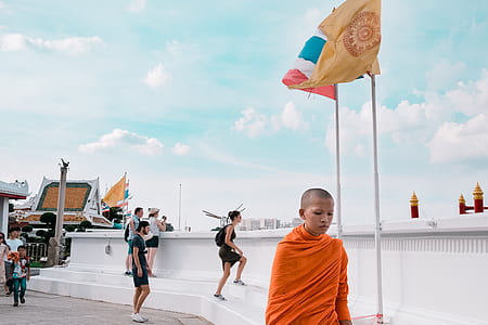 boy walking near flag post thumbnail