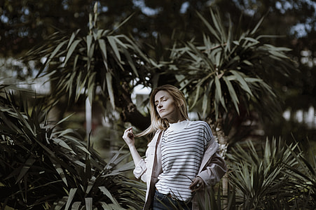 woman standing beside green plant during daytime thumbnail