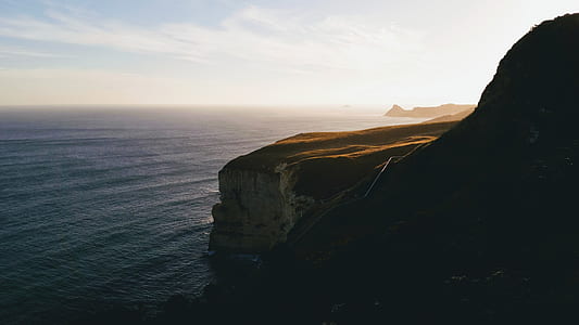 calm sea near rock cliff at daytime thumbnail