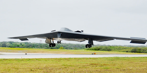 gray aircraft below green grass field thumbnail