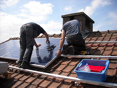two man putting solar panels on roof thumbnail